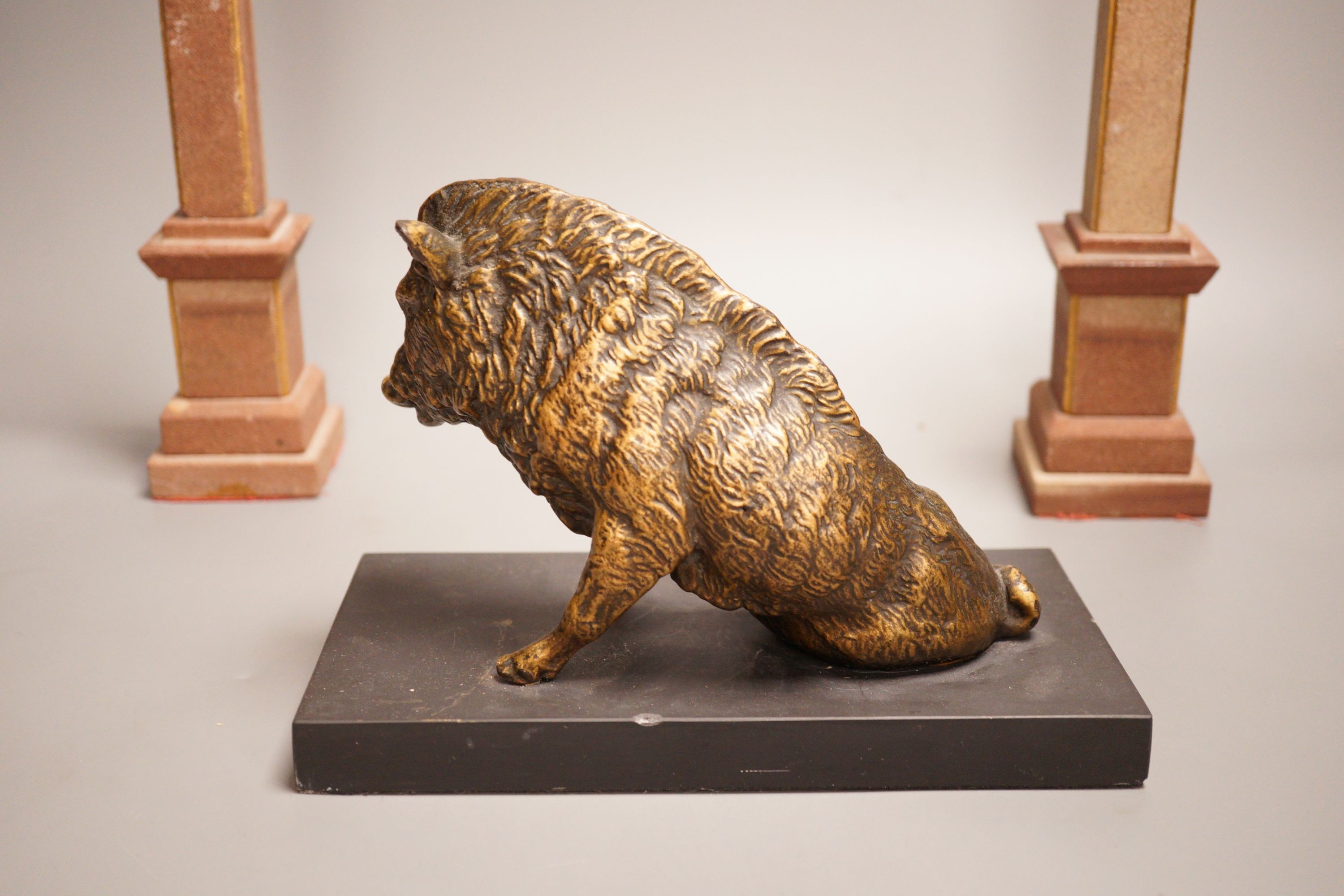 After the antique, a bronzed composition model of the Borghese boar together with a pair of reconstituted stone obelisks, 28cm